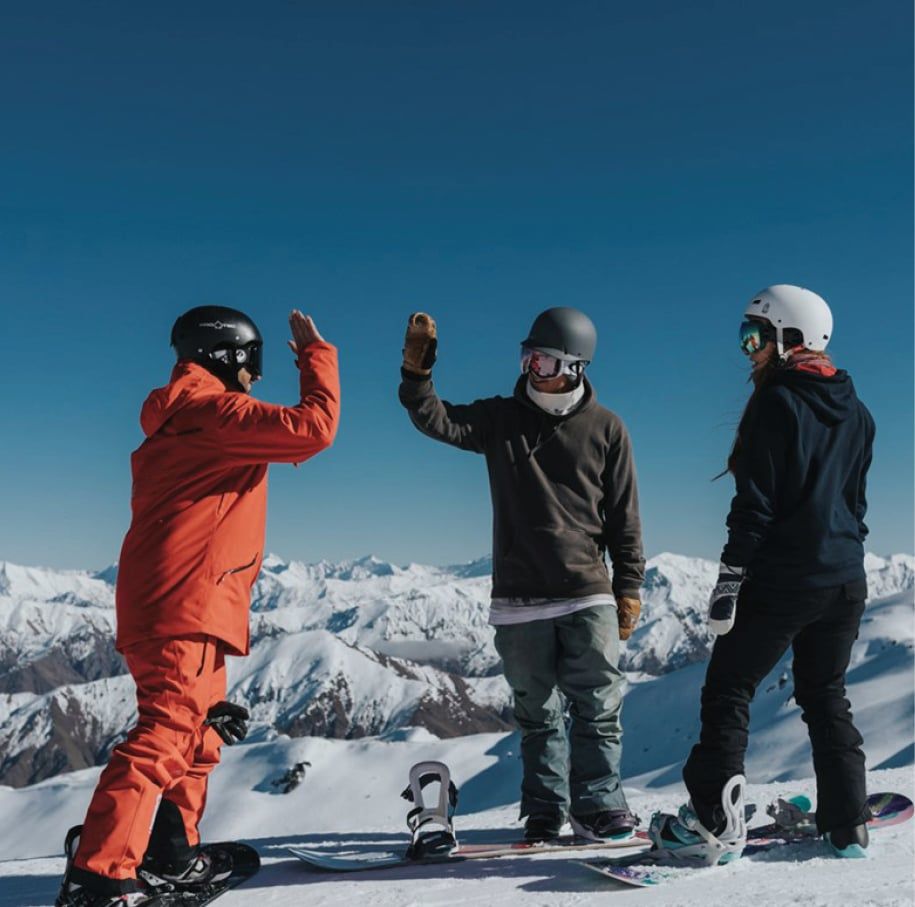 Three skiers hi-five